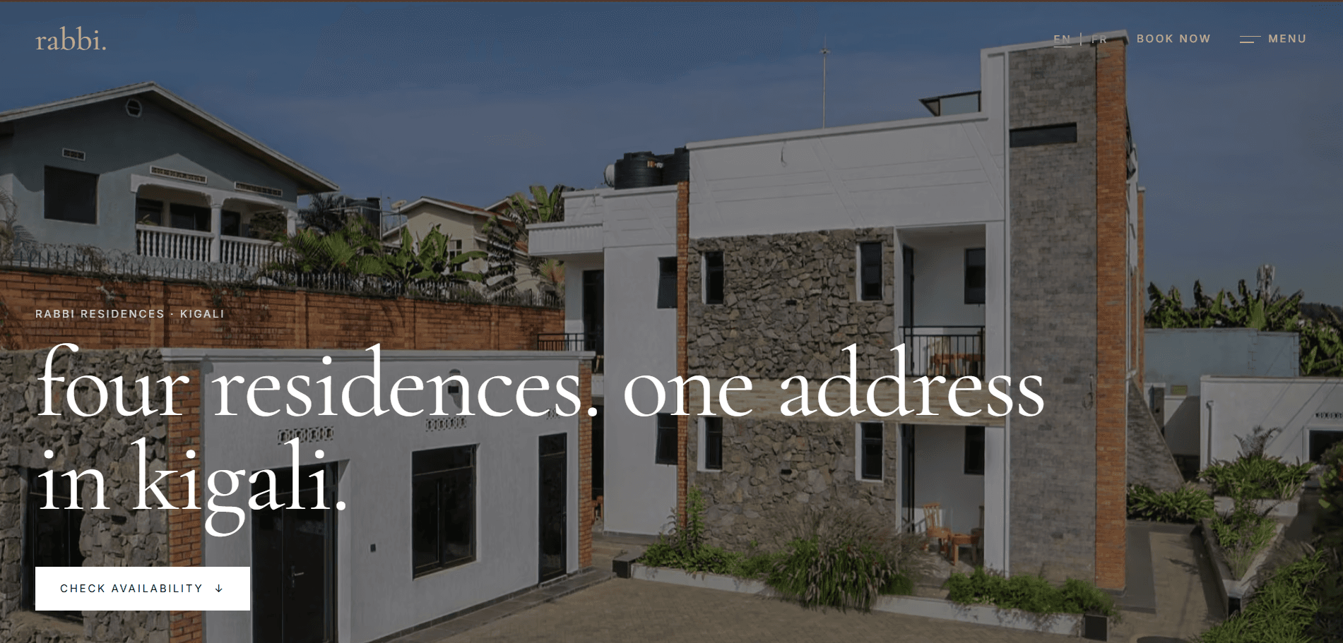 The Rabbi Residences homepage: a white and stone residence in Kigali under the line “four residences. one address in kigali.”